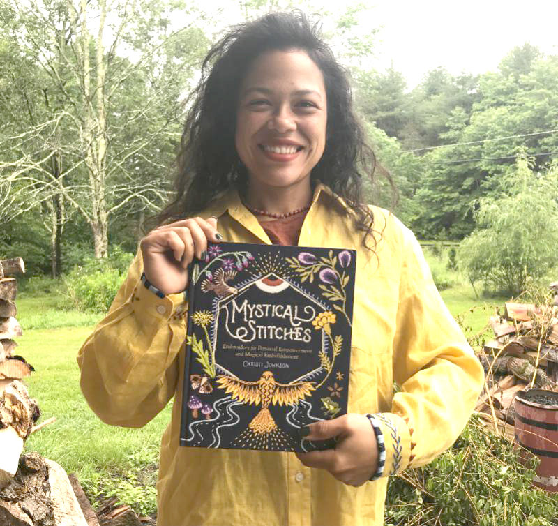 Christi Johnson shown here with her new book, “Mystical Stitches.”